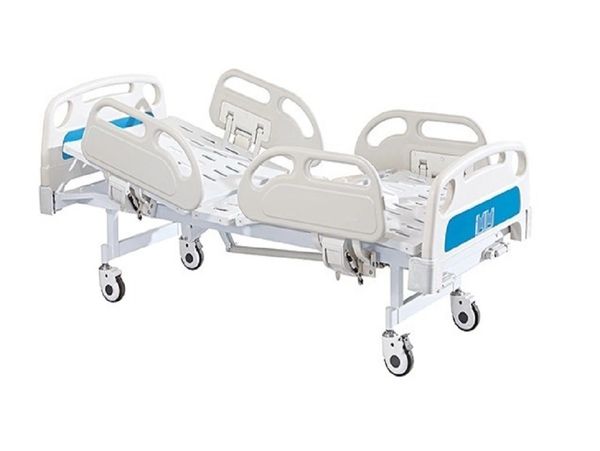 Adjustable hospital bed with side rails and wheels for mobility.