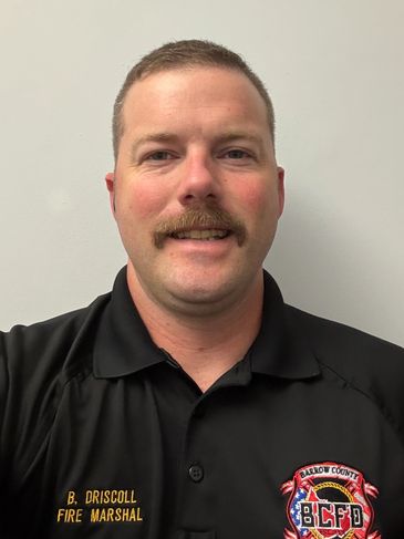 Man in fire marshal uniform with mustache.