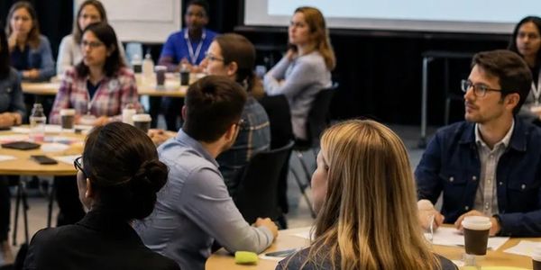 People attentively listening in a conference or seminar setting.