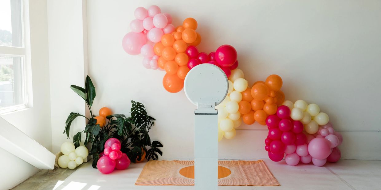 PhotoLounge.ca set up of our digital tablet based photo booth with balloons in the background.