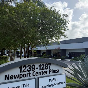 Building with a sign for Newport Center Plaza.