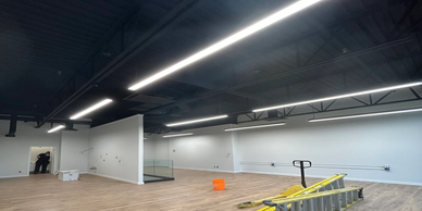 Interior of an unfinished commercial space with construction materials.