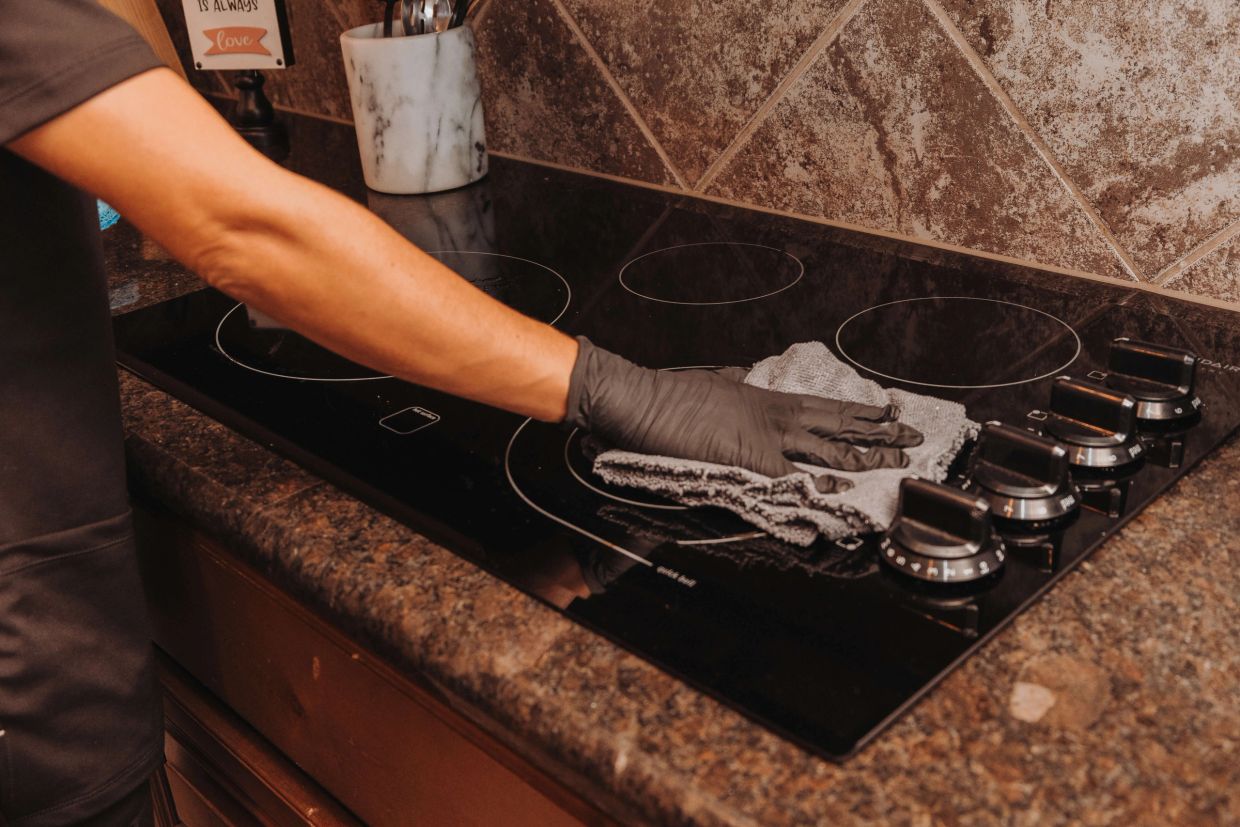 Grace Home Cleaning deep cleaning oven interior during kitchen cleaning service in Rockwall, TX