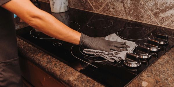 Grace Home Cleaning deep cleaning an oven in Rockwall, TX