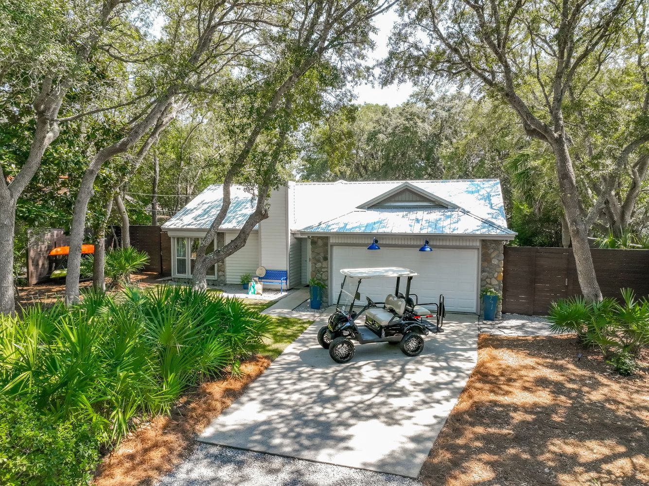 Stack of books next to pencils in a holder and a camera.