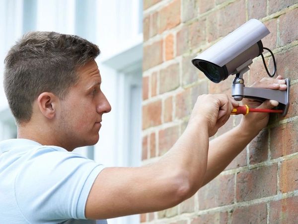 A professional installing a CCTV camera