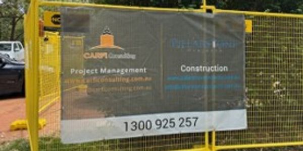 Construction site banner displaying project management and construction services contact info.