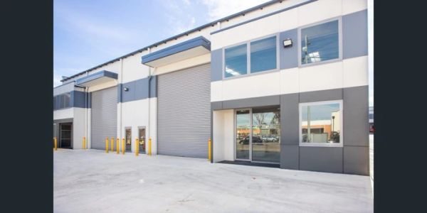 Modern warehouse with large roller doors and office space.