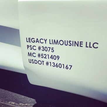 Legacy Limousine DOT stickers on white bus door