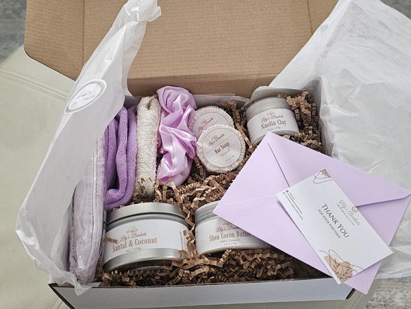 Spa gift box with clay, scrunchy, eye cover, socks, loofah sponge, soap, body oil, candle & b