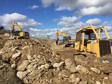 residential excavation - site grading on slope with dozers and trackhoe