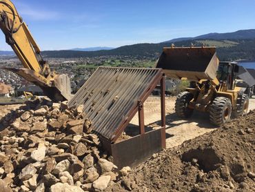 residential excavation - rock removal with trackhoe, grizzly screen, and wheel loader