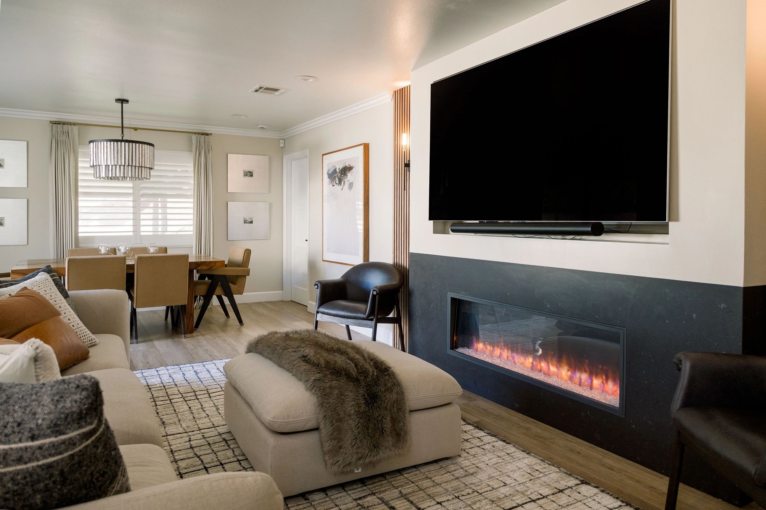Family room view of TV, fire place, seating area and partial dinning area. 
