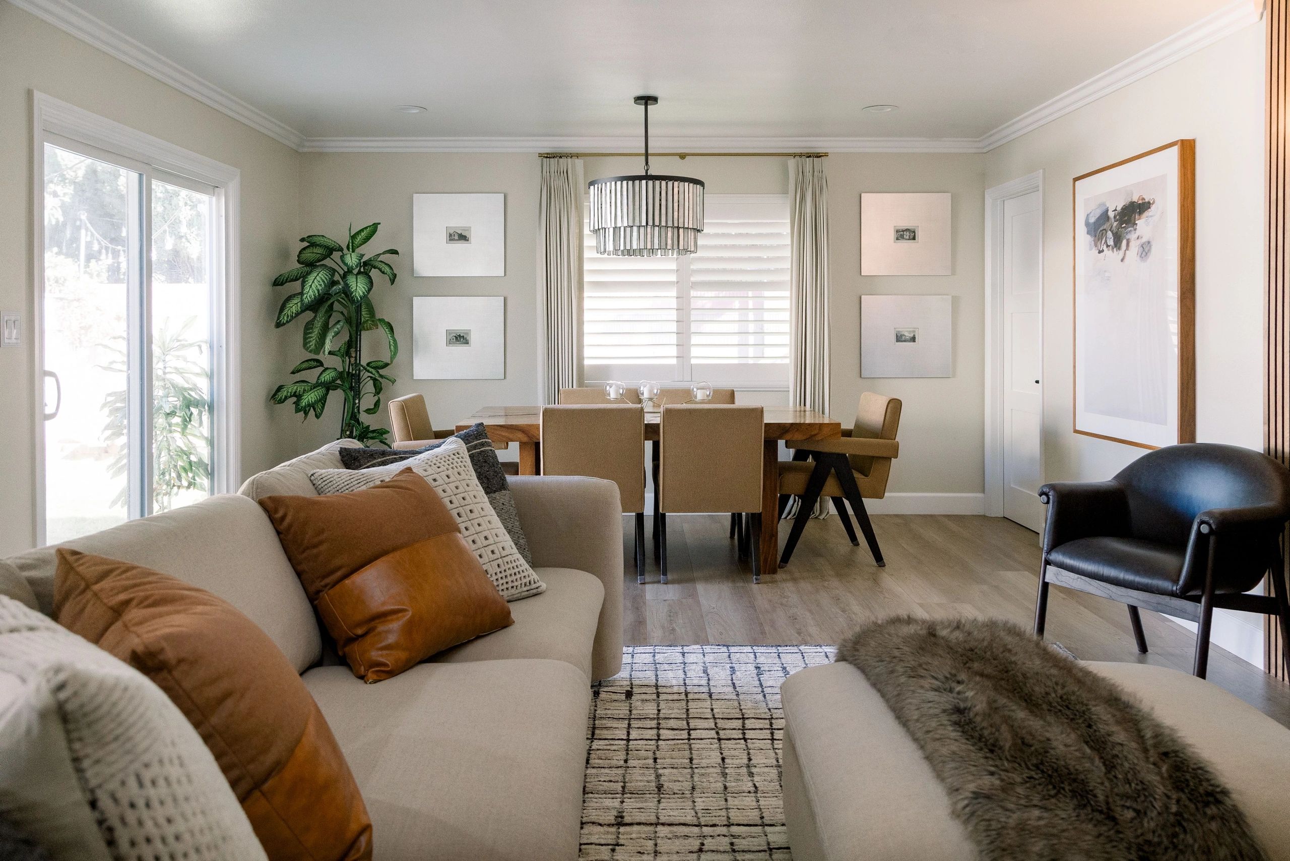 Family room seating area and dining table with white, grey and wooden brown accents. 
