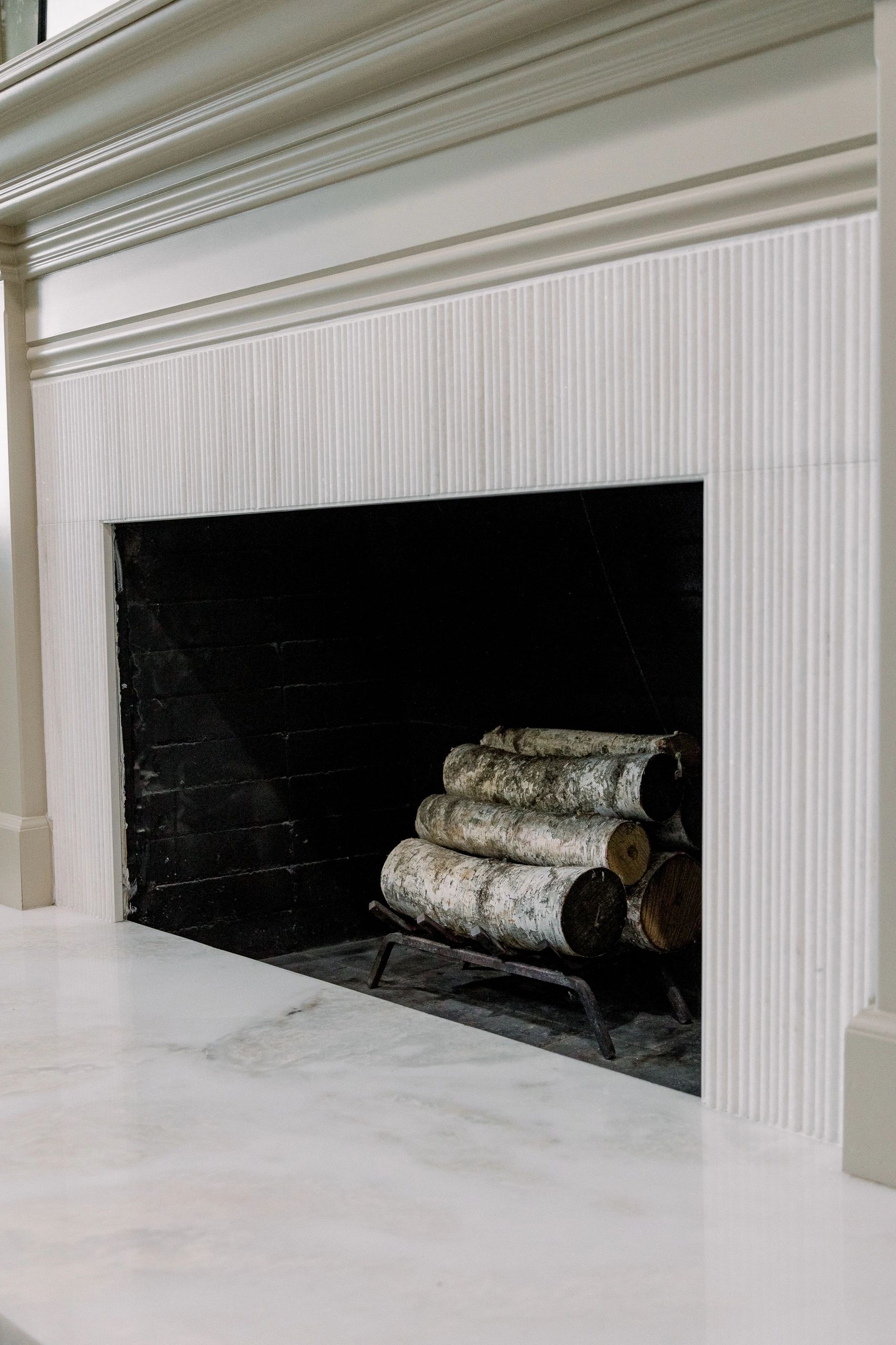 Inside chimney view with logs stacked ready to be lit. 