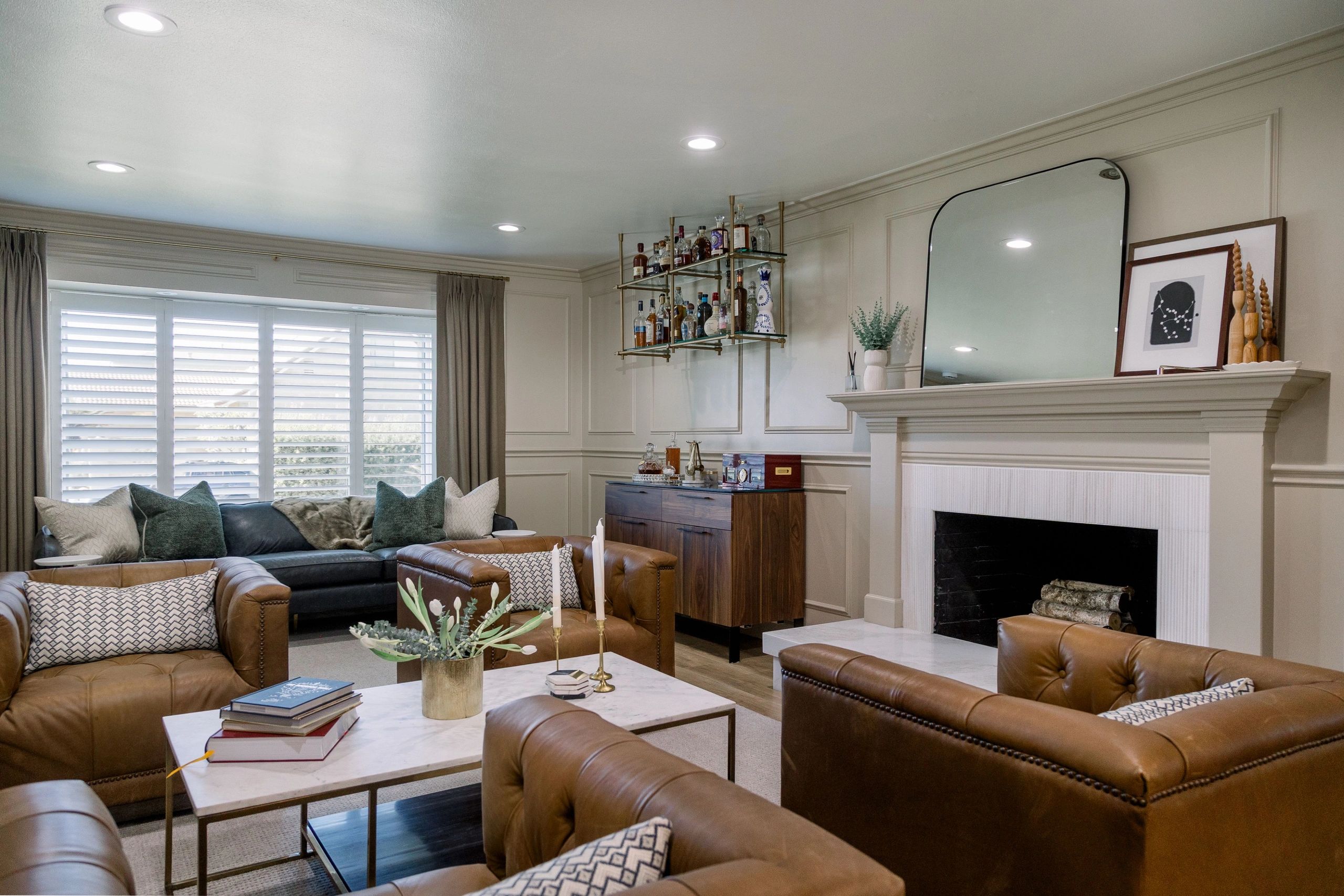 Wide view of living room with bar in the far left and seating area mid center. 