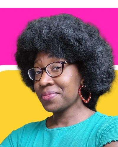 An image of Lizzy - the owner of the fantastic foundations wearing a green top with a big afro.