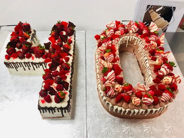 custom carved anniversary cake with fruit and candy