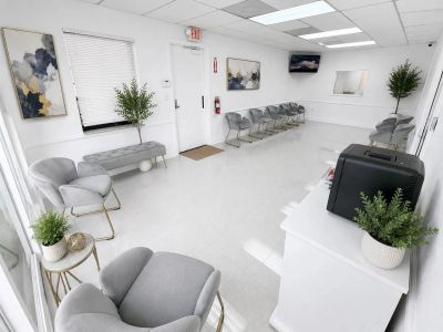 Clean and modern waiting room with gray chairs.