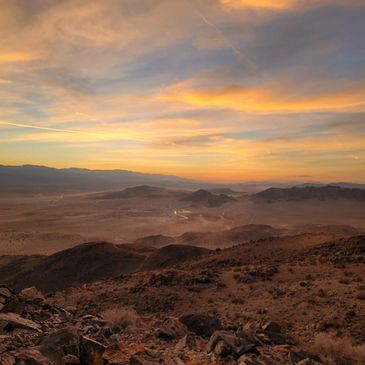 Desert landscape at sunset with colorful sky.