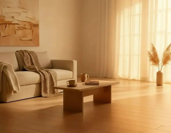 Cozy minimalist living room with beige tones, a sofa, and soft natural light.