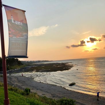 ALT=Rocky Harbour Newfoundland at sunset a setting in Sagas & Sea Smoke