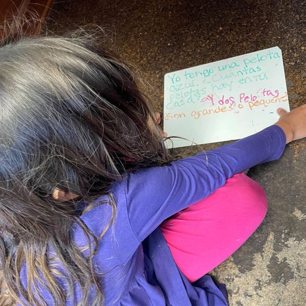 Student reading and writing in Spanish