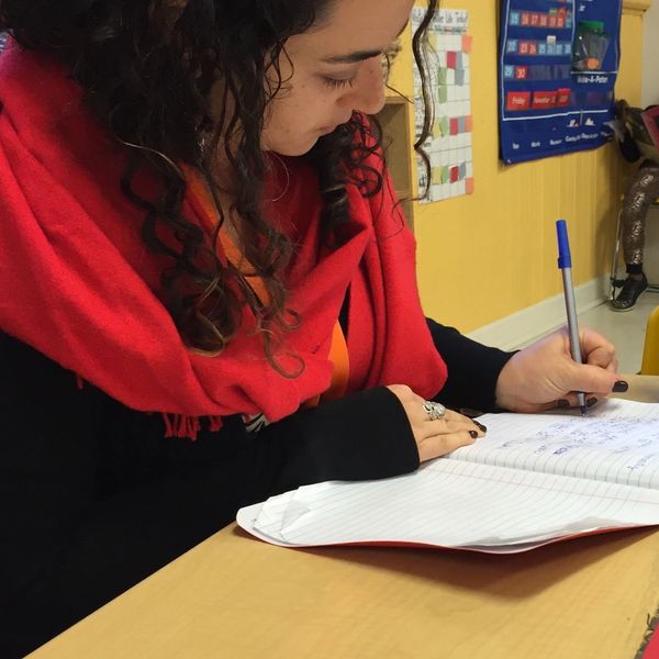 Kindergarten teacher Liz Rosenberg writing notes in classroom