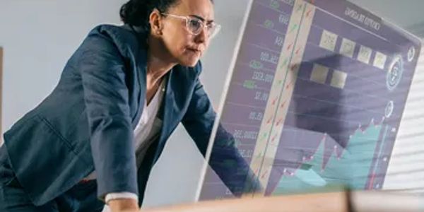 Focused businesswoman analyzing virtual data charts.