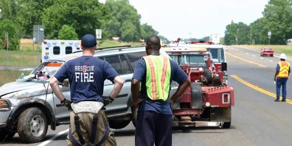 Fire rescue workers at a vehicle accident scene.