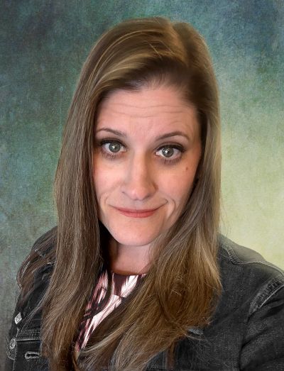 Woman with long brown hair posing for a photo.