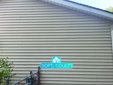 Warped and buckling vinyl siding on a house exterior.