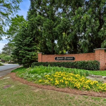 Entrance sign to Shirley Forest neighborhood surrounded by greenery.