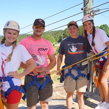 Guests preparing to zip line at Ron Coleman with the assistance of our zip line staff