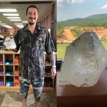 Man holding a large quartz crystal point unearthed at Ron Coleman Mine in Jessieville, AR