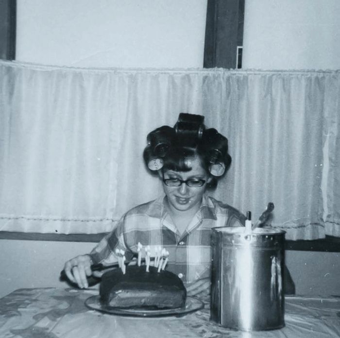 Mona on her 16th birthday with homemade cake, hand-churned ice cream and curlers in her hair. 