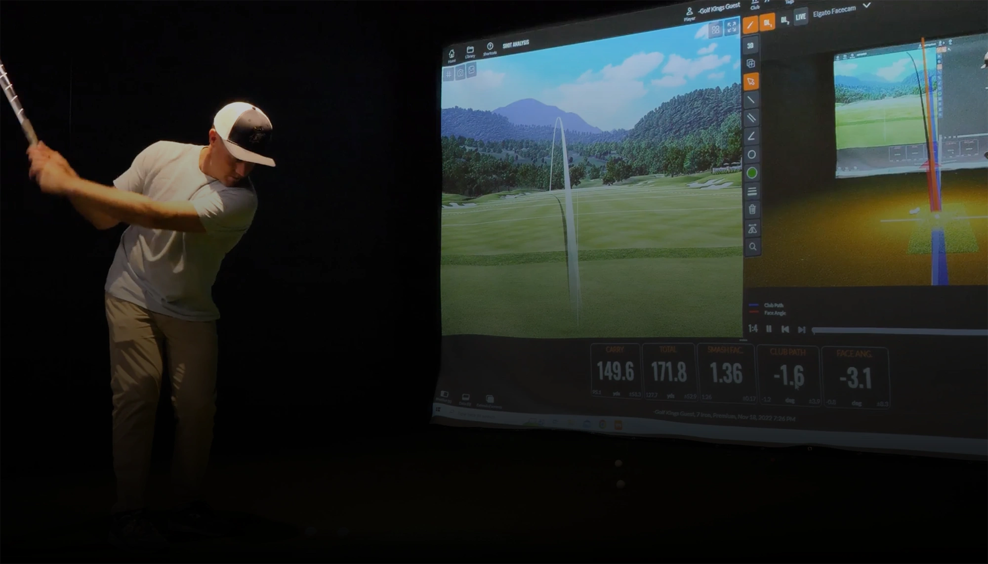 Guy playing on an indoor golf simulation game
