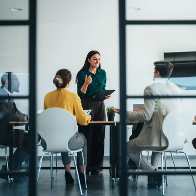 Professionals meeting in a bright, contemporary workplace.
