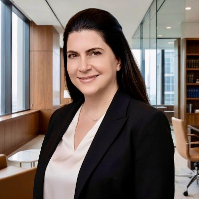 Professional woman smiling in office setting.
