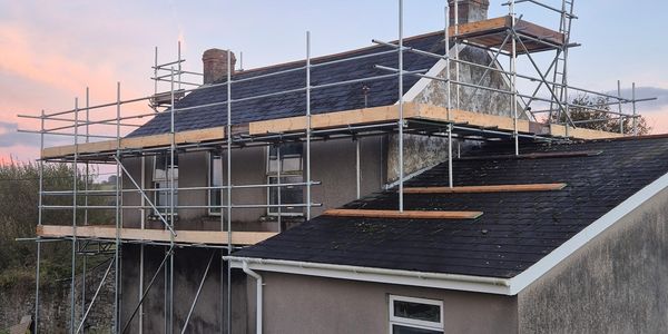 Scaffolding around a large farm house 