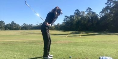 Junior athlete hitting wedges into a tour variance grid