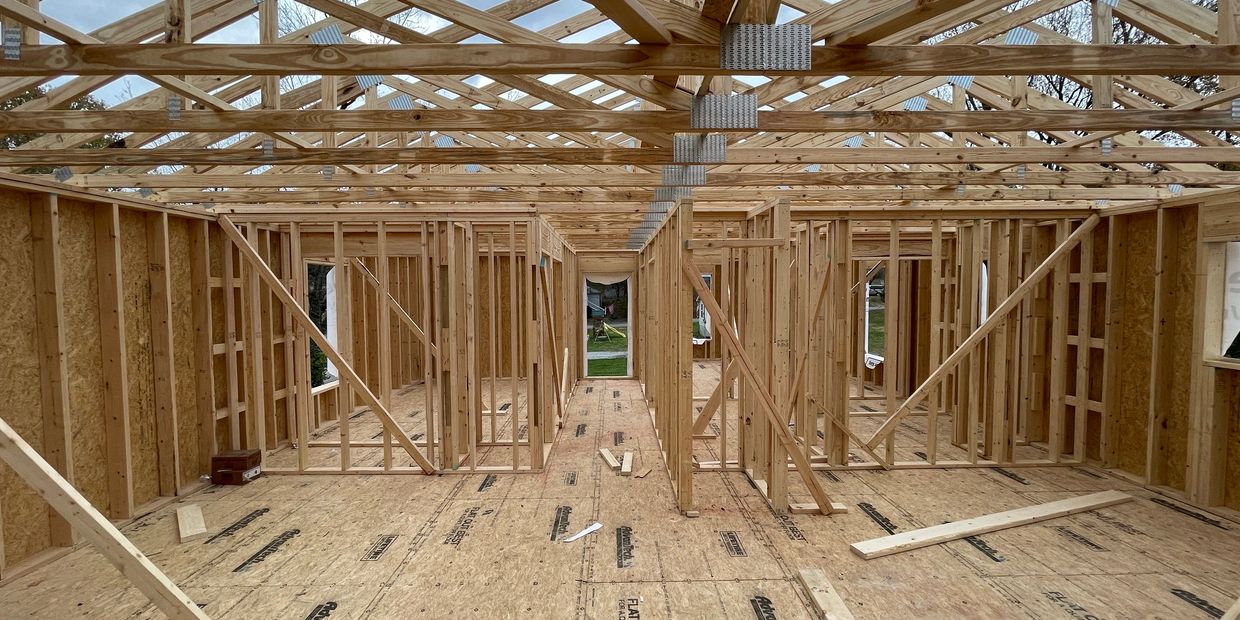 Under Construction house with walls and trusses.
