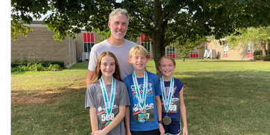Father and his children after they had just finished the 10K.