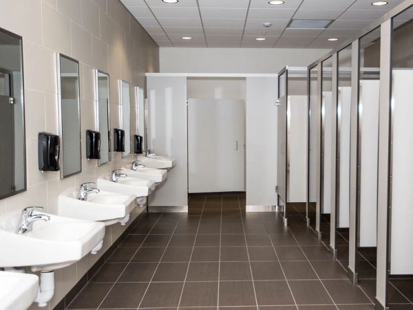 A clean public restroom with sinks and stalls.