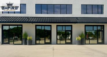Modern commercial building with reflective glass doors and windows.