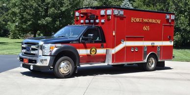 Red ambulance truck labeled Fort Morrow 603.