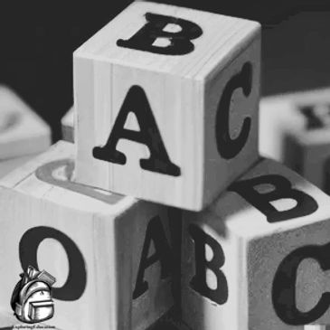 Three blocks with letters of the alphabet on the sides.