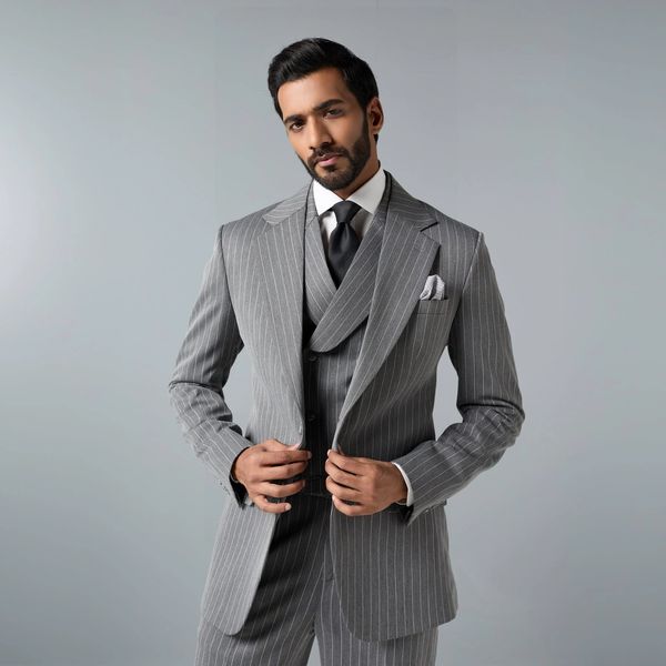 Man in a gray pinstripe suit with a black tie.