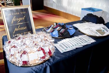 Table with glitzy face masks and a sign inviting guests to take one