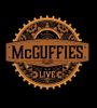 Rustic McGuffies Live sign with gear graphic.
